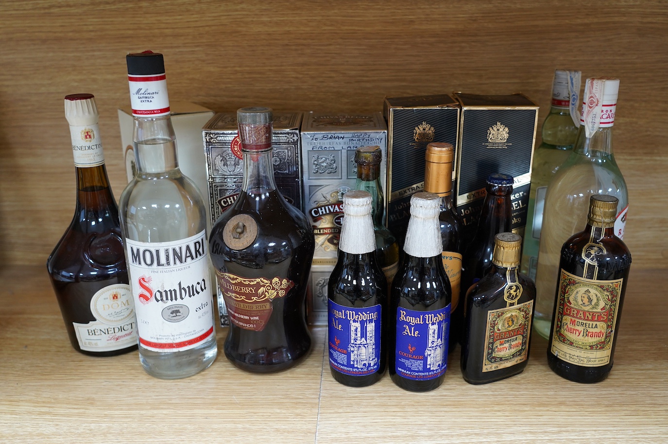 Seventeen bottles of spirits, ales etc. including Johnnie Walker Back Label, Chivas Regal, etc. Condition - fair